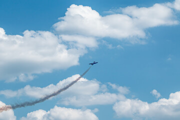Jet Plane with Contrails in Cloudy Sky