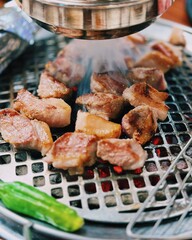 Grilled samgyeopsal, thick slices of pork belly with a perfect balance of crispy edges and tender meat. Served with lettuce, garlic, and dipping sauces for a classic Korean barbecue experience.
