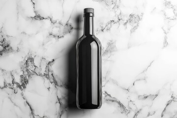 Glossy black bottle with a label mockup on a marble background.