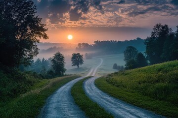 Obraz premium A quiet country lane at sunset with silhouettes of trees along the path.
