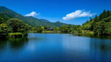 Fototapeta premium Tranquil Lake Surrounded by Lush Greenery and Mountain Landscape