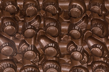 Brown plastic package for candy or similar confectionery products, fragment