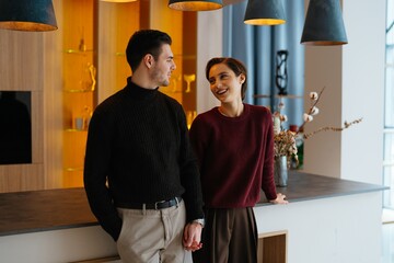 Couple sharing a joyful moment in a modern interior setting