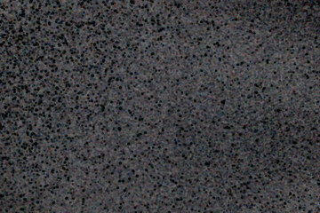 Closeup view of black dotted texture on a dark gray surface background