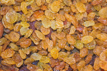 Golden raisins spread out on a surface displaying their natural color and texture in a kitchen setting