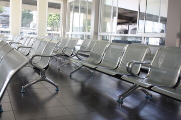 Waiting area with metal chairs in station, or bank, office, hospital