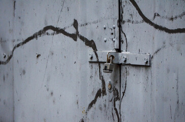 Side view of a garage lock on a gray garage.