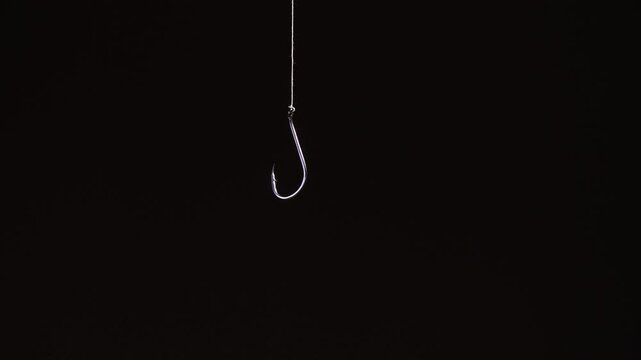 Fishing hook hanging in the dark void