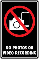 Sign indicating prohibition of photos and video recording, shown with a camera and phone crossed out with a red circle, on black background.
