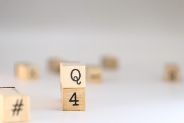 Fourth quarter acronym. word Q4 written on wooden cubes isolated on white background with copy space. Concept of business concept, end of year 