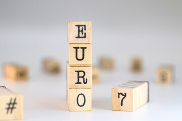The word euro 7 written on wooden cubes on a white background with space for text. Concept of European standards