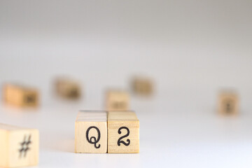 Second quarter acronym. word Q2 written on wooden cubes isolated on white background with copy space. Concept of Business Accounting, Automotive classification, Quarters