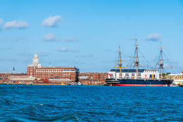 Fototapeta premium A view from Gosport towards the historic dockyard at Portsmouth, UK in early Autumn