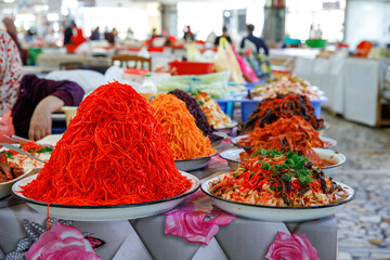 Stand with different fresh salads at Chorsu Bazaar, a market in Tashkent, Uzbekistan
