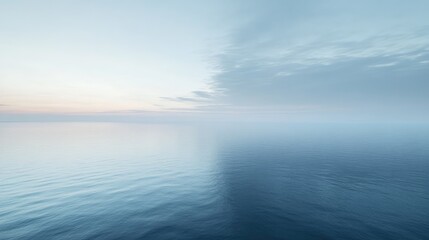 A soft morning sky in shades of pale blue, with a faint glow near the horizon.