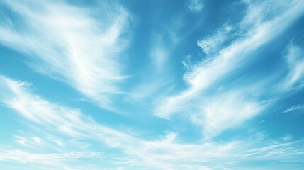 Obraz premium A vast, light blue sky with a few wispy white clouds drifting gently, creating a peaceful and airy atmosphere.