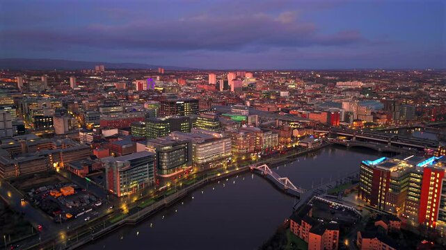 Aerial drone film of downtown city centre Glasgow with squiggly bridge clyde river