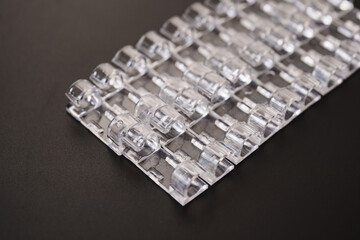 Lots of clear plastic wire holders on the black surface. details for a comfortable life and aesthetics.