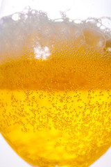A bubbles in a glass of foamy beer on a white background. cooling drink. 