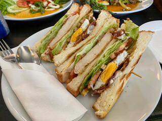 Chicken club sandwich with fried egg