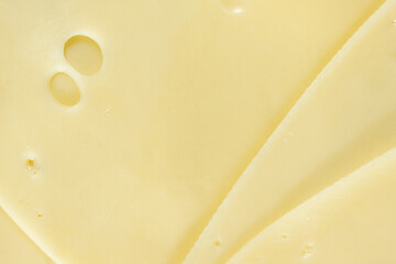 Semi-hard cheese close-up, thin slices, top view