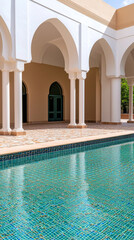 Luxurious pool with mosaic tiles and elegant architecture in sunny courtyard