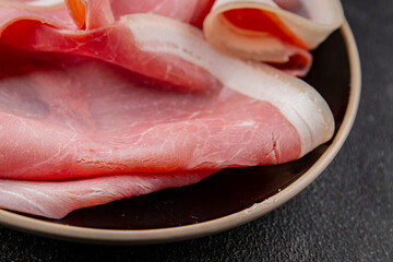 Ham slices pork meat delicious gourmet food background on the table rustic food top view copy space