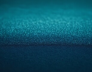 Abstract close-up of shimmering teal and blue textures with a smooth gradient.