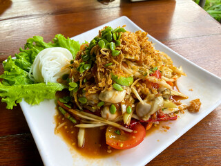 Som Tam, Thai spicy papaya salad with raw shrimps and noodles