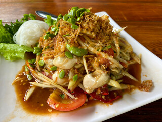 Som Tam, Thai spicy papaya salad with raw shrimps and noodles