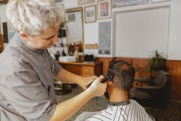 In a stylish barbershop setting, a barber meticulously and expertly cuts a clients hair with skill