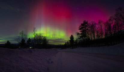 A beautigul autora borealis display over the snowy Norvegian winter landscape. Northern lights in...