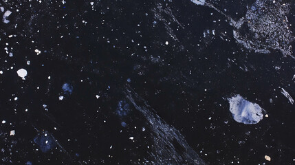 Fototapeta premium Textured asphalt surface with cracks and potholes for urban background design