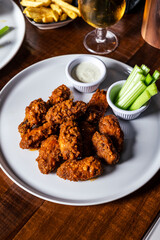 Hot Crispy Chicken wings on wooden restaurant table