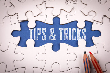 Fototapeta premium Tips & Tricks. White puzzle pieces and colored pencils