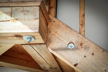 Close-Up of Wooden Beam Construction with Metal Bolts in Rustic Architectural Design