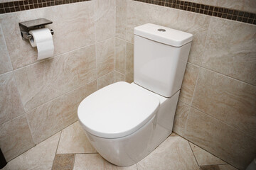 An ordinary white toilet in the interior of the bathroom. plumbing for the home.