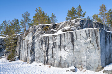 Marble rock in the old Italian quarry on a sunny February day. Ruskeala Mountain Park. Karelia,...