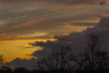 Fototapeta premium a large grey cloud against a reddish-yellow eastern sky