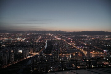 Evening Beijing city skyline with mountains in background
