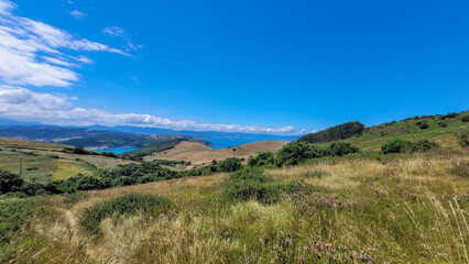 Obraz premium Grassland Pathway Leading to Green Hills in Basque Country, Spain