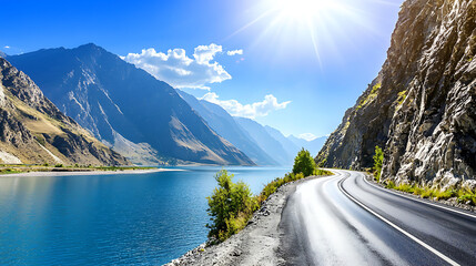 A mountain range with a road running along the side of a lake