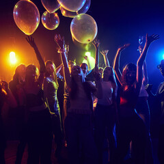 Group of young friends at a dynamic and festive party, celebrating birthday or holiday together,...