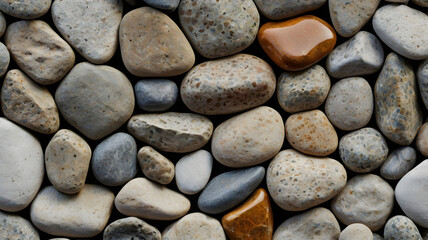 a collection of smooth, colorful river rocks. The image showcases a range of colors and textures, creating a visually interesting and abstract background.  