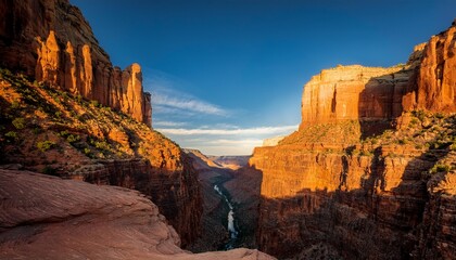 A canyon illuminated by the golden hour, with warm, soft light casting long shadows and highlighting the rugged textures of the landscape.