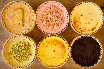 Overhead photograph of several cheesecakes of different flavors
