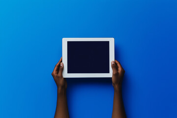 Tablet in hands: a person is holding a tablet with a blank screen, set against a vibrant background. Perfect for showcasing apps, designs, or digital content. 