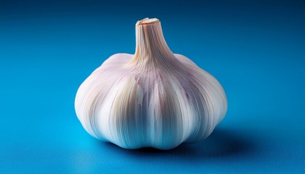 a close up of a garlic bulb on a blue surface