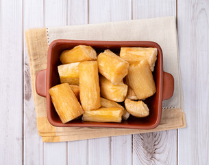 Traditional brazilian fried manioc in a plate over wooden table