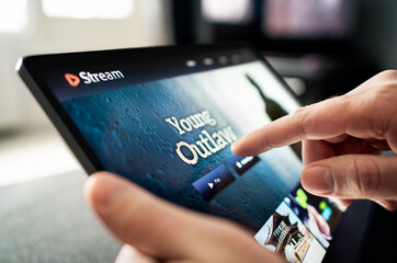 Stream with tablet. Movie or video on laptop. Watching series. Streaming service content on screen. TV or VOD subscription. Choosing on demand entertainment. Scrolling selection. Catalogue mockup.